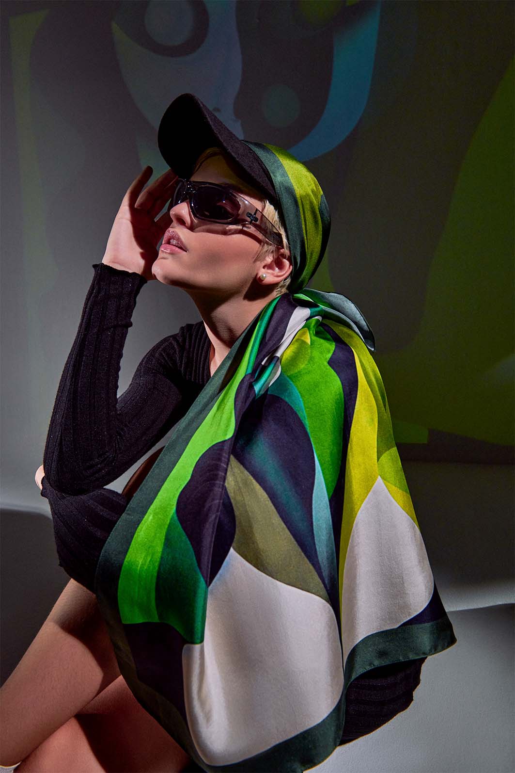 Model wearing Aporia Unease scarf with green tones, surreal style inspired by René Magritte.