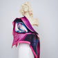 The "Elpída" scarf draped over a statue, emphasizing luxury and artistic expression.