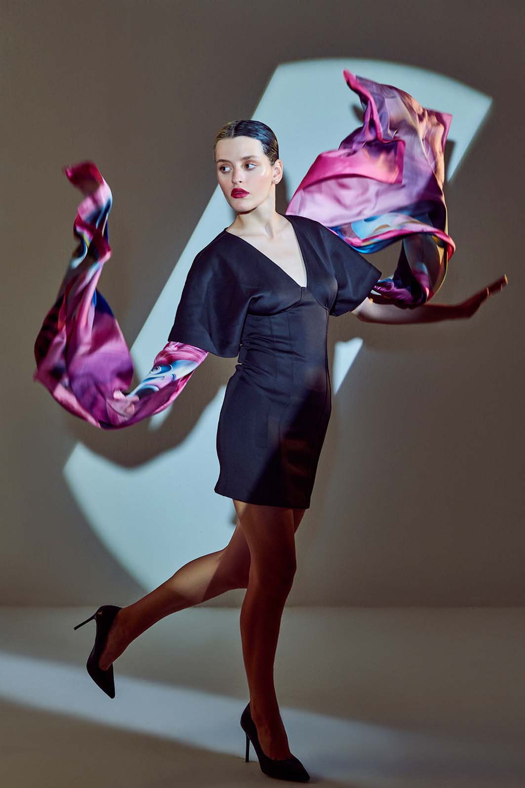 Model showcasing the "Elpída" scarf in a dynamic pose, symbolizing hope and elegance.