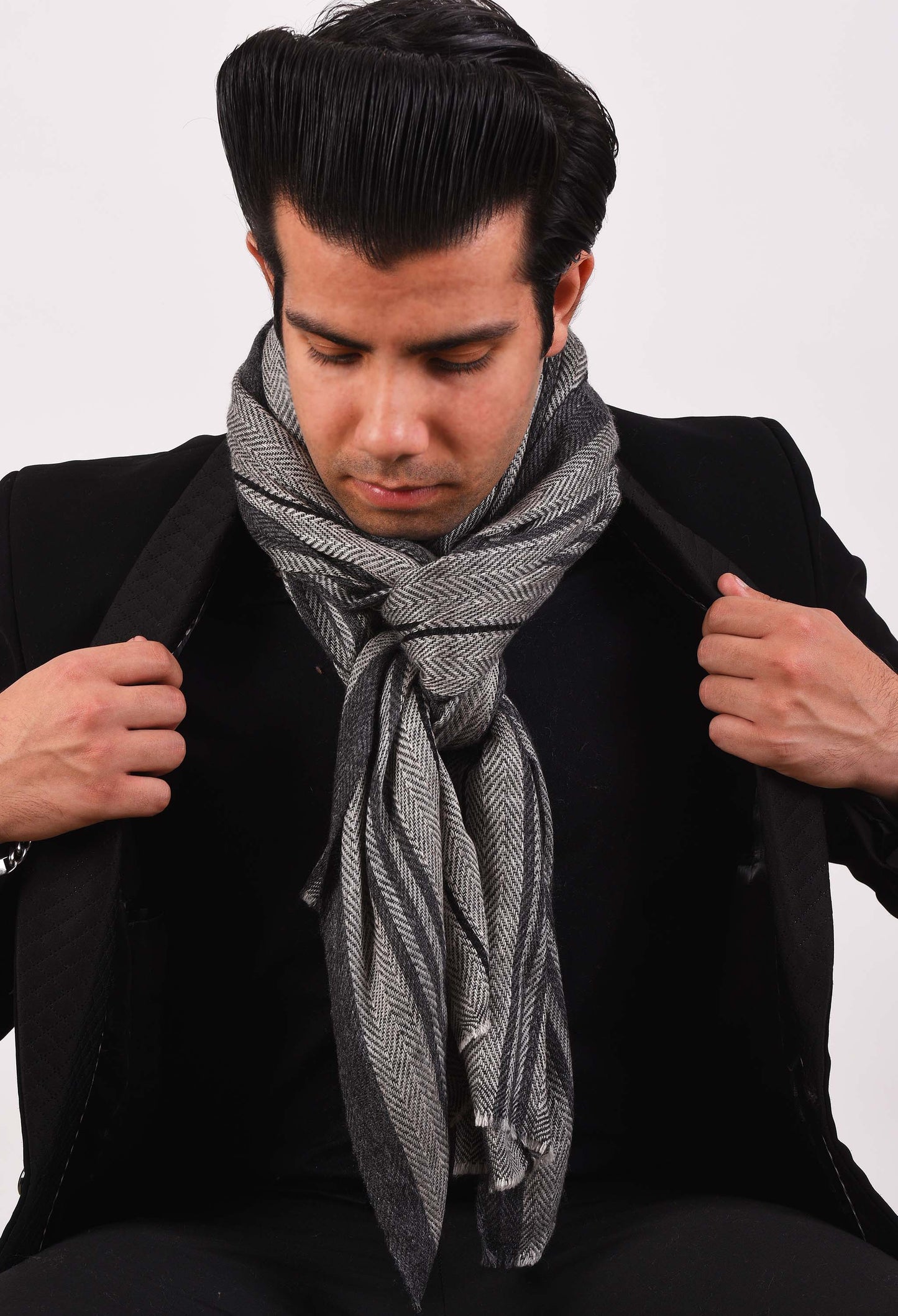 Man wearing the Aria camel wool stole over a black suit, showcasing winter elegance.