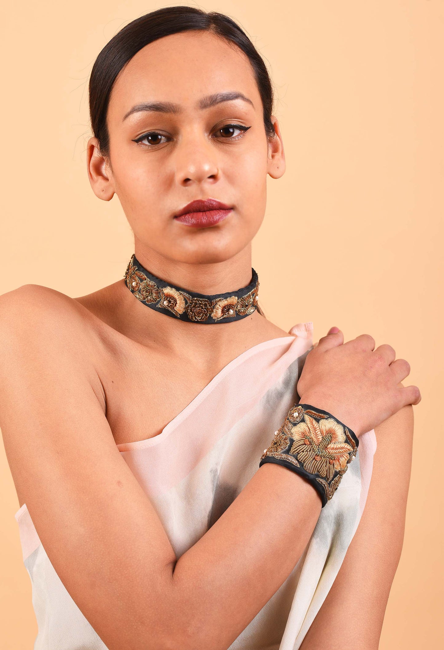 Model wearing Aristocracy handcrafted choker and bracelet set, showcasing intricate Indian-inspired design.