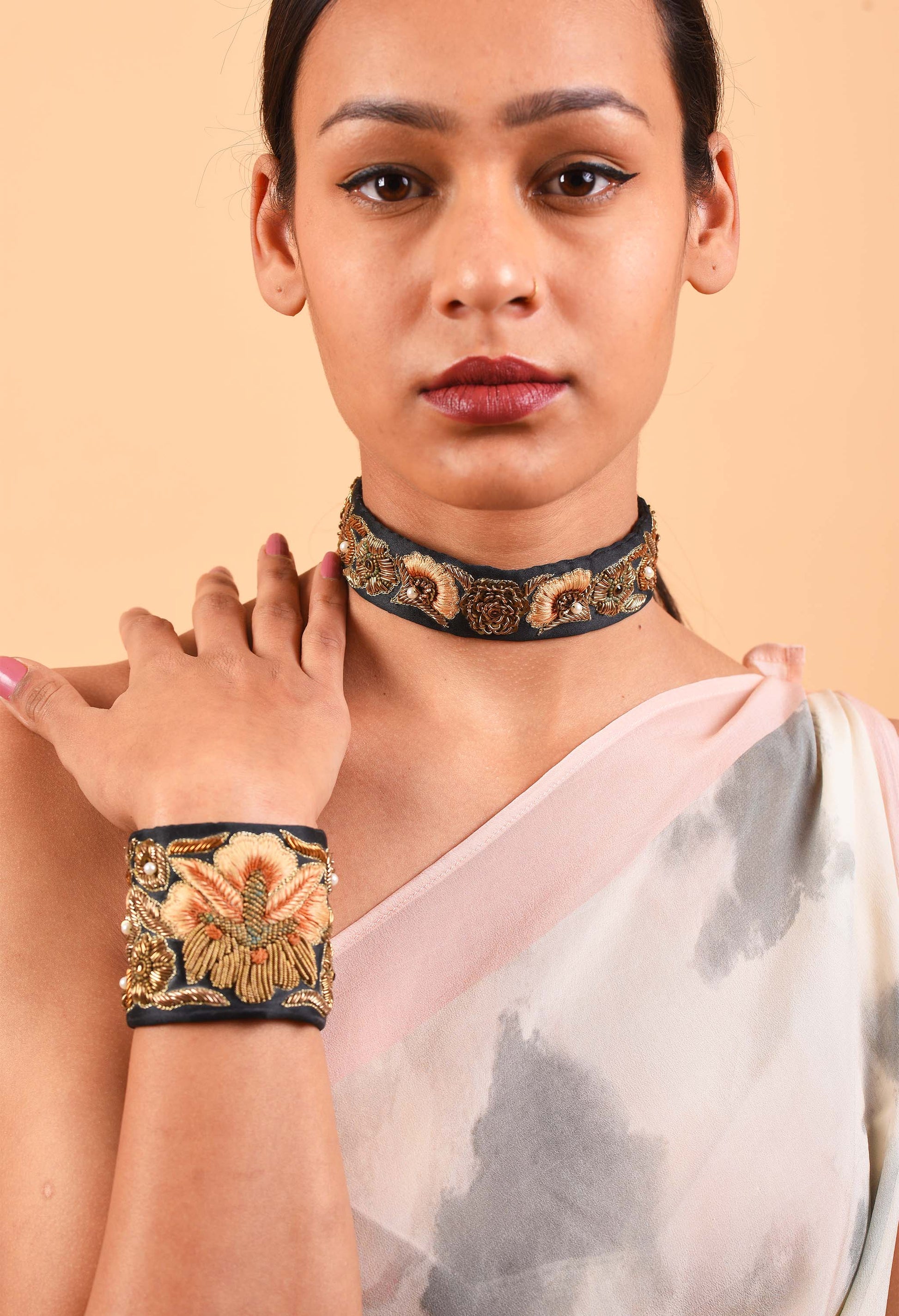 Close-up of model wearing Aristocracy choker and bracelet set, highlighting detailed craftsmanship and luxury aesthetic.