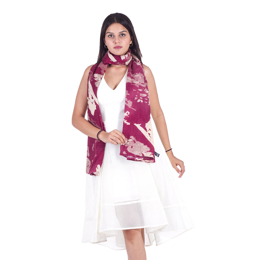 Woman in white dress with Freeque's Berry Grunge scented shawl wrapped around neck, showcasing its luxurious flow.