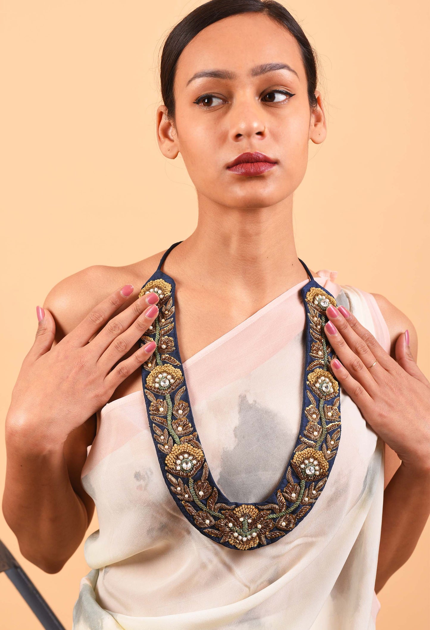 Model wearing Blue Manor handcrafted jewelry necklace inspired by Indian weaving traditions.