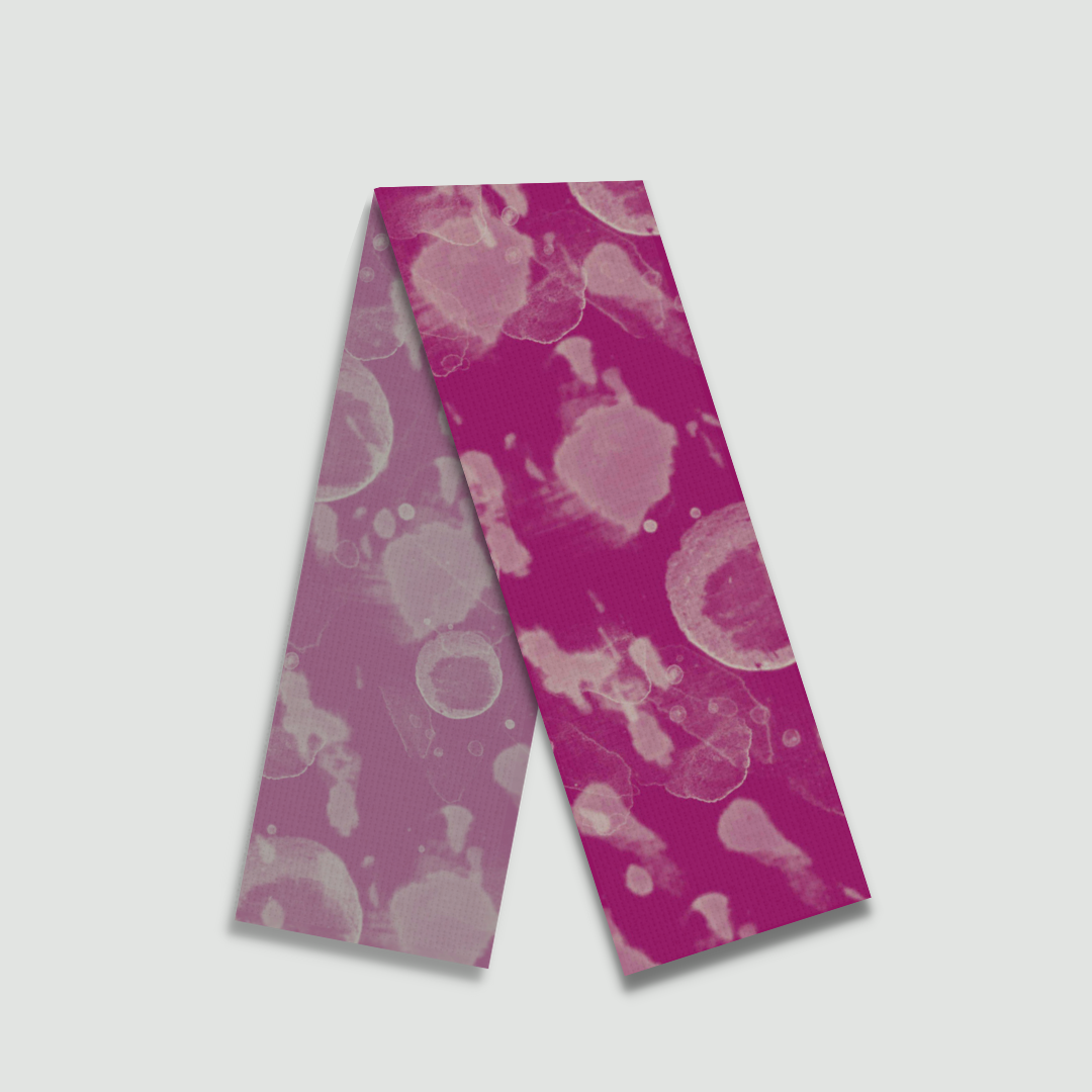 Flat lay of Freeque’s Bubble Blast stole in deep red with abstract circular patterns, showcasing satin modal fabric.