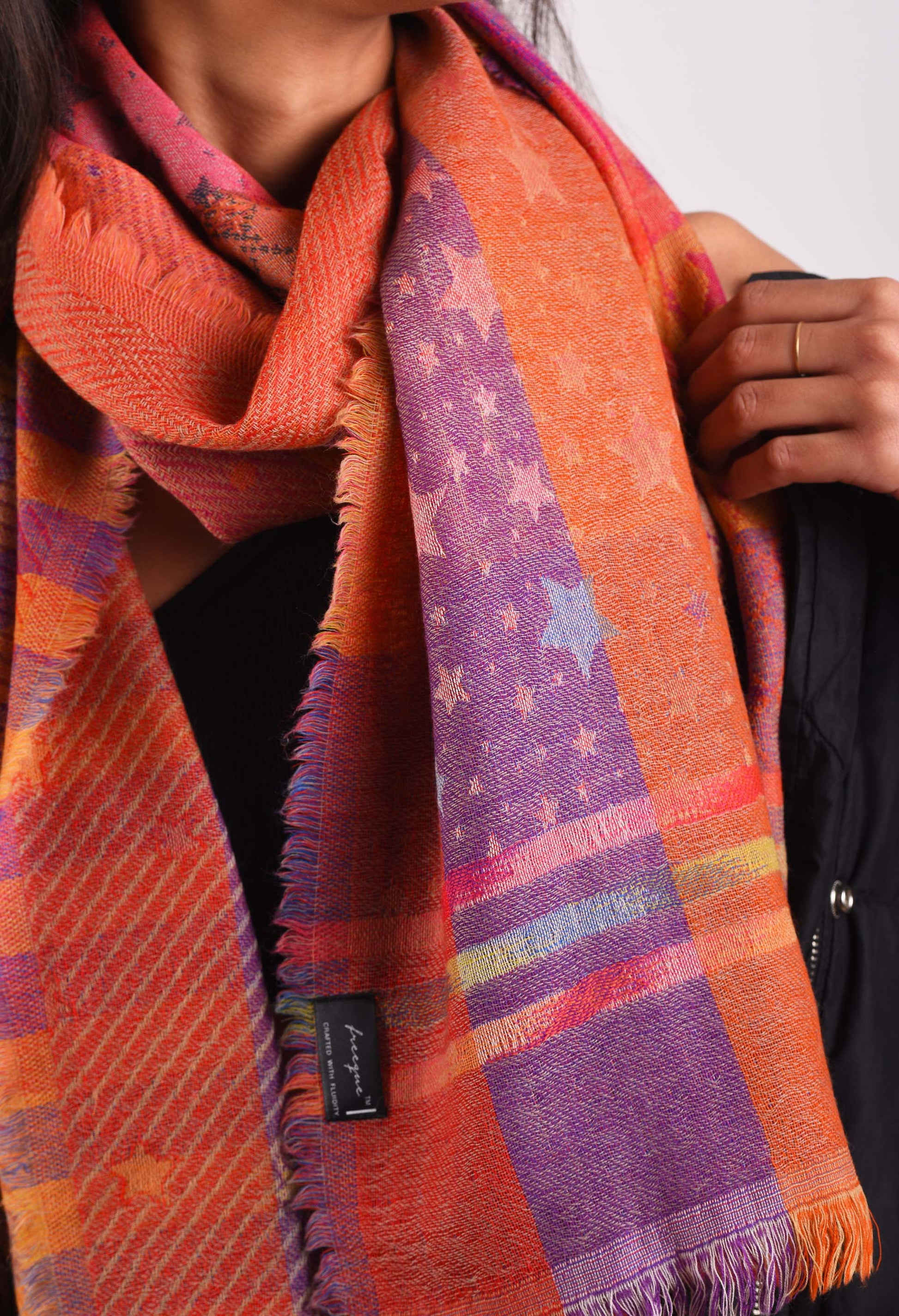 Close-up of Duchess camel wool stole with intricate weaving and vibrant colors.