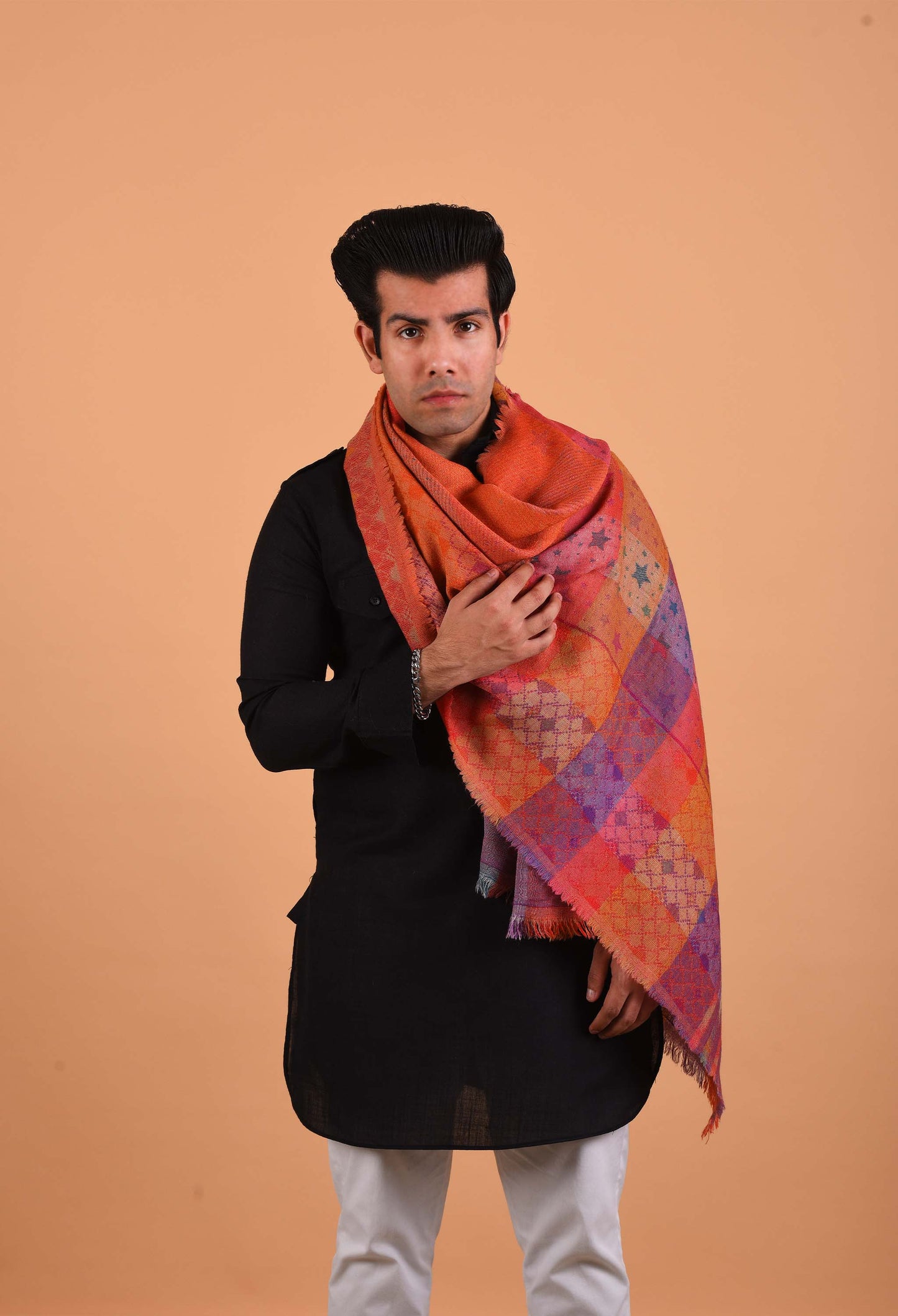 Model wearing a vibrant orange and purple Duchess camel wool stole in a traditional style.