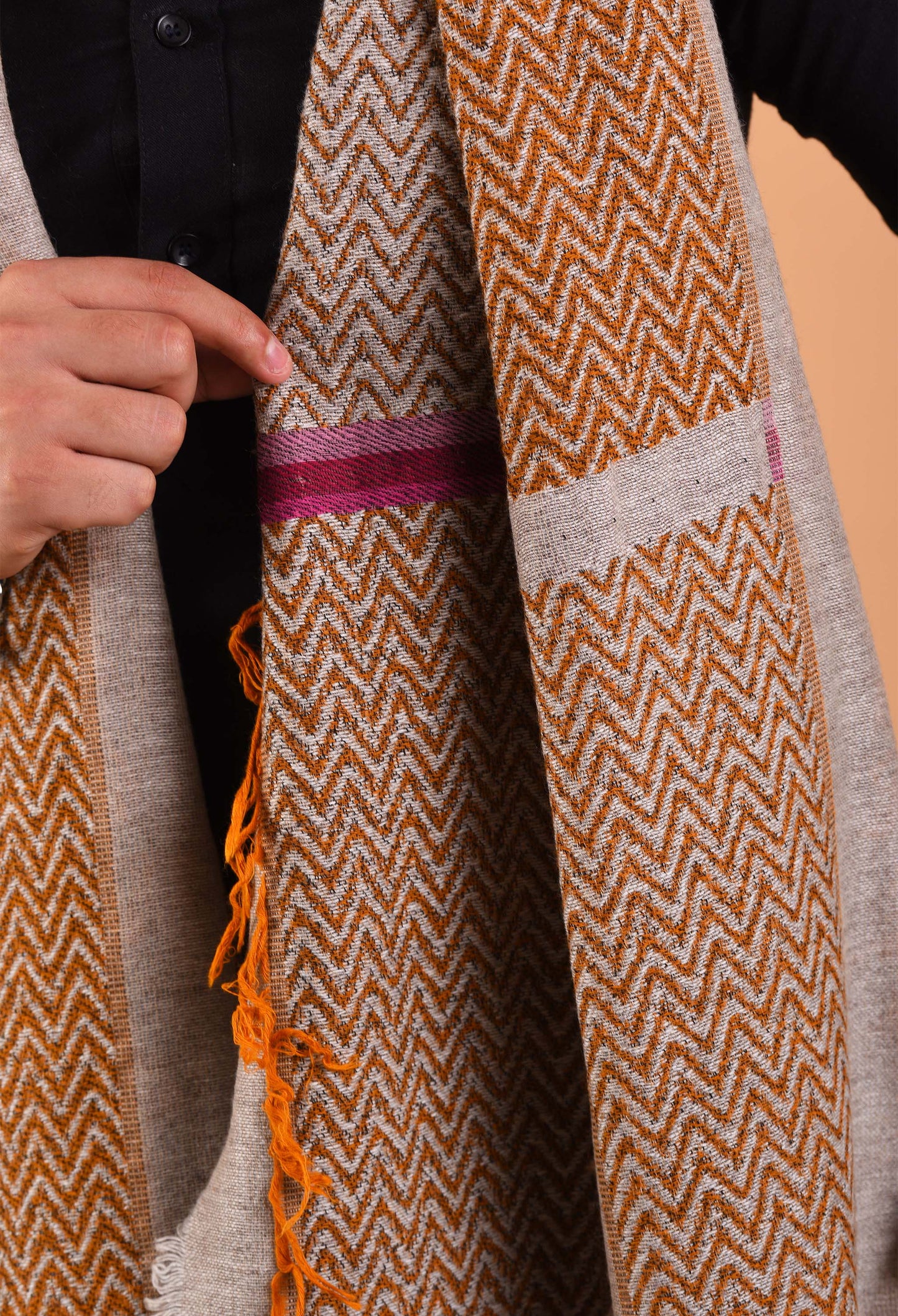 Close-up view of Flynn stole in camel wool showcasing intricate patterns and craftsmanship