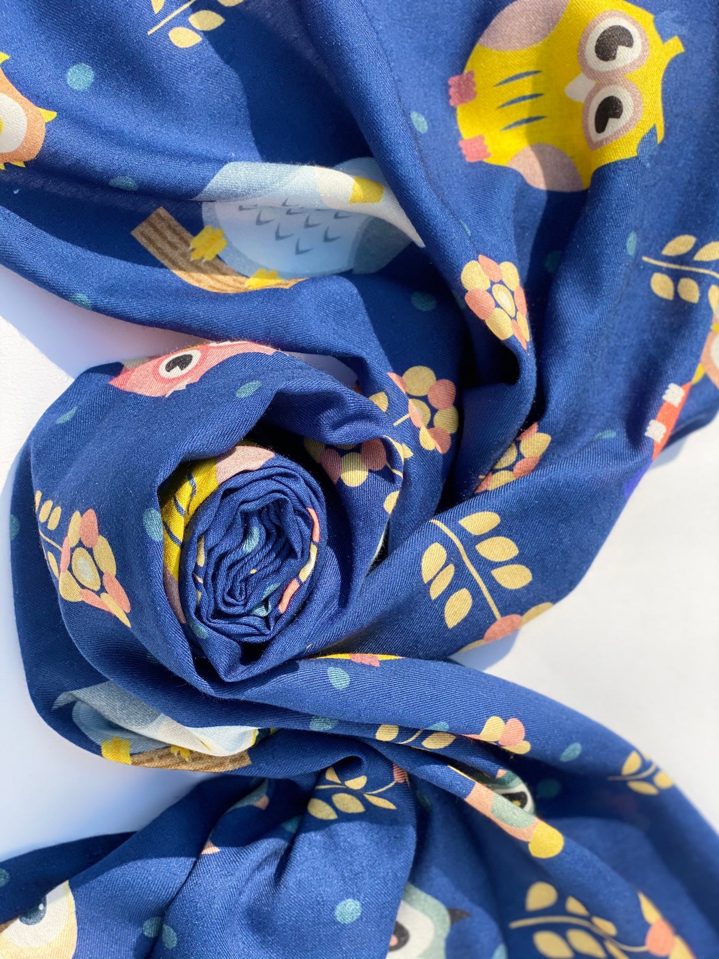 Rolled "Night Owl" scented stole with detailed owl pattern and floral accents on blue fabric