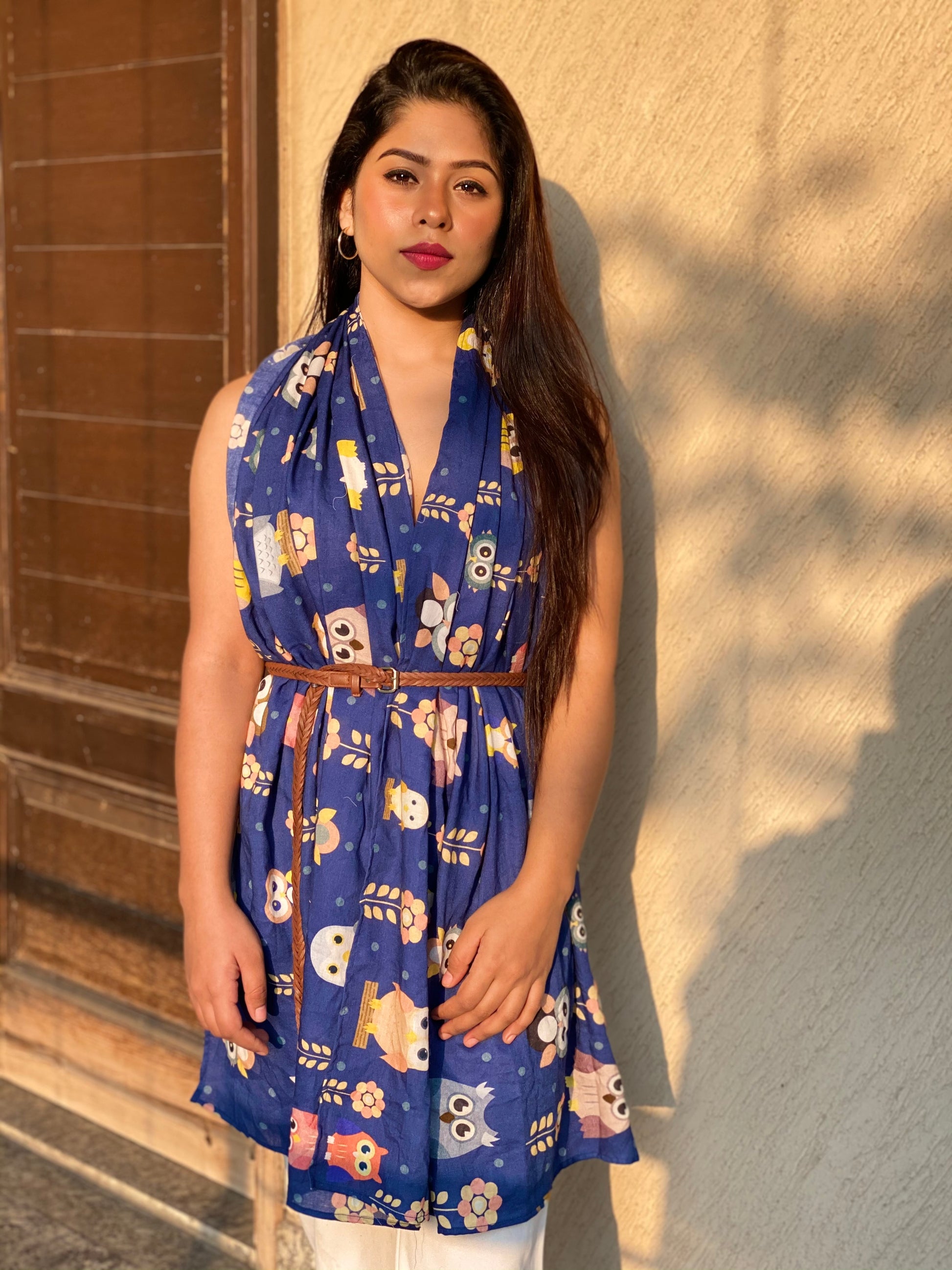 Woman wearing the blue "Night Owl" scented stole with an owl pattern, styled as a dress