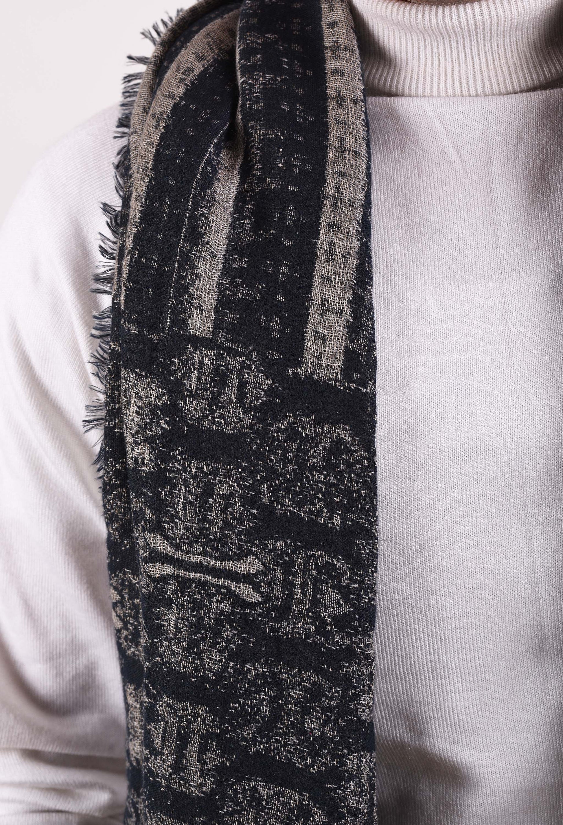 Detailed shot of the texture and pattern of Saige camel wool stole.