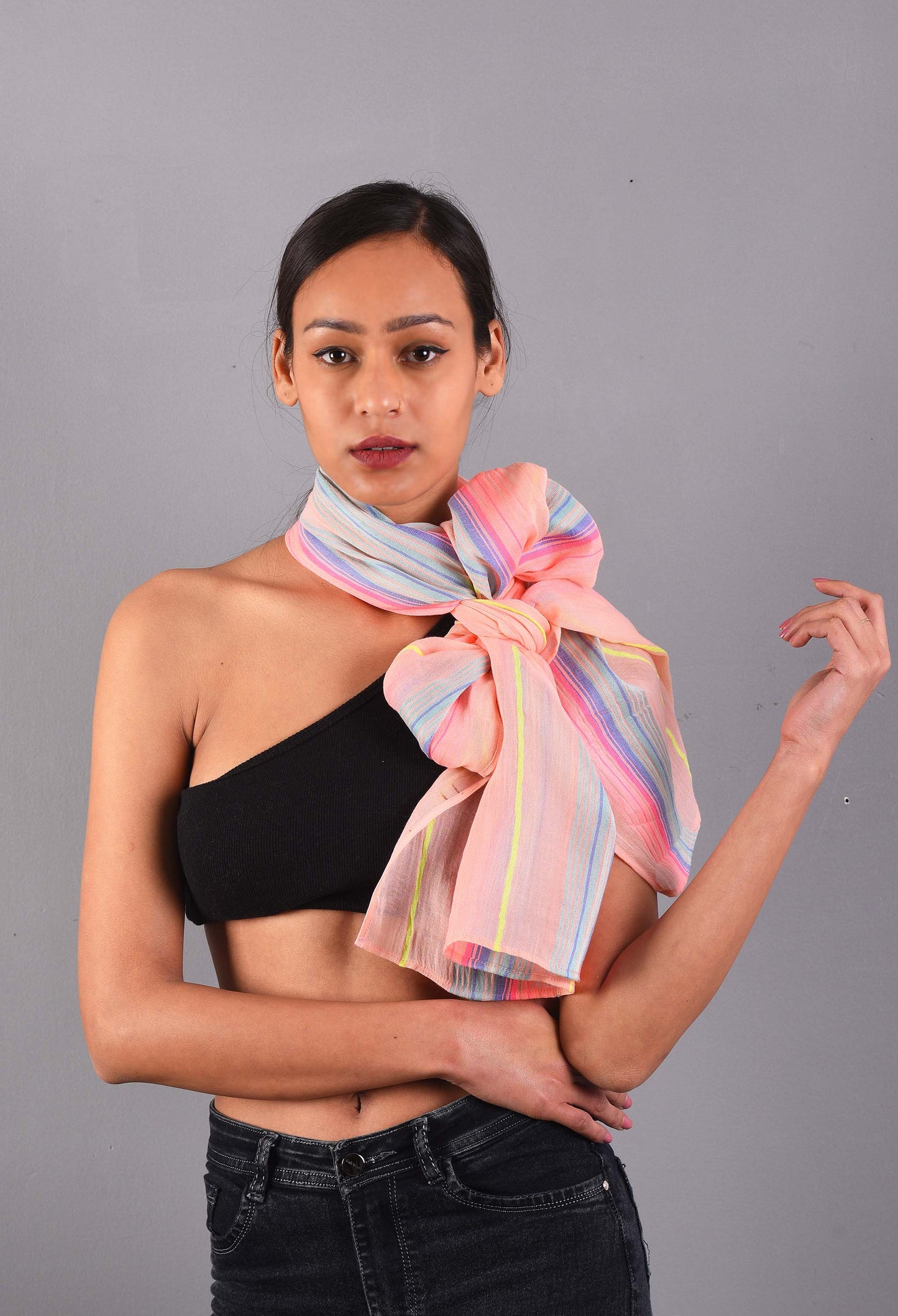 Model wearing a Salmon Streak scented stole with a large bow style, crafted from 100% viscose by Freeque.